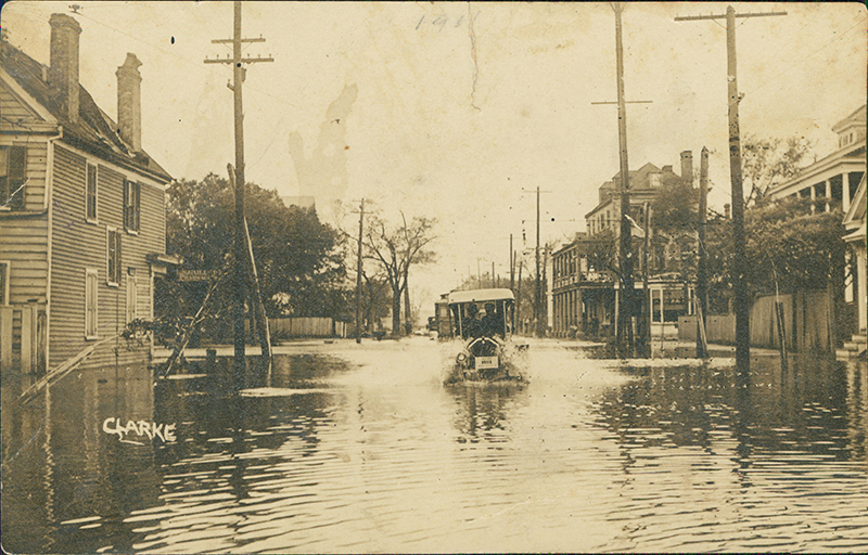 1,000 Years of Floods: As these vintage images show, flooding in Charleston is nothing new. (Above) a pencil marking indicating “1911” suggests this car, sloshing down the street most likely near the corner of Rutledge and Calhoun, was a victim of the September 1911 flood.  Photograph courtesy of Ed Reynolds
