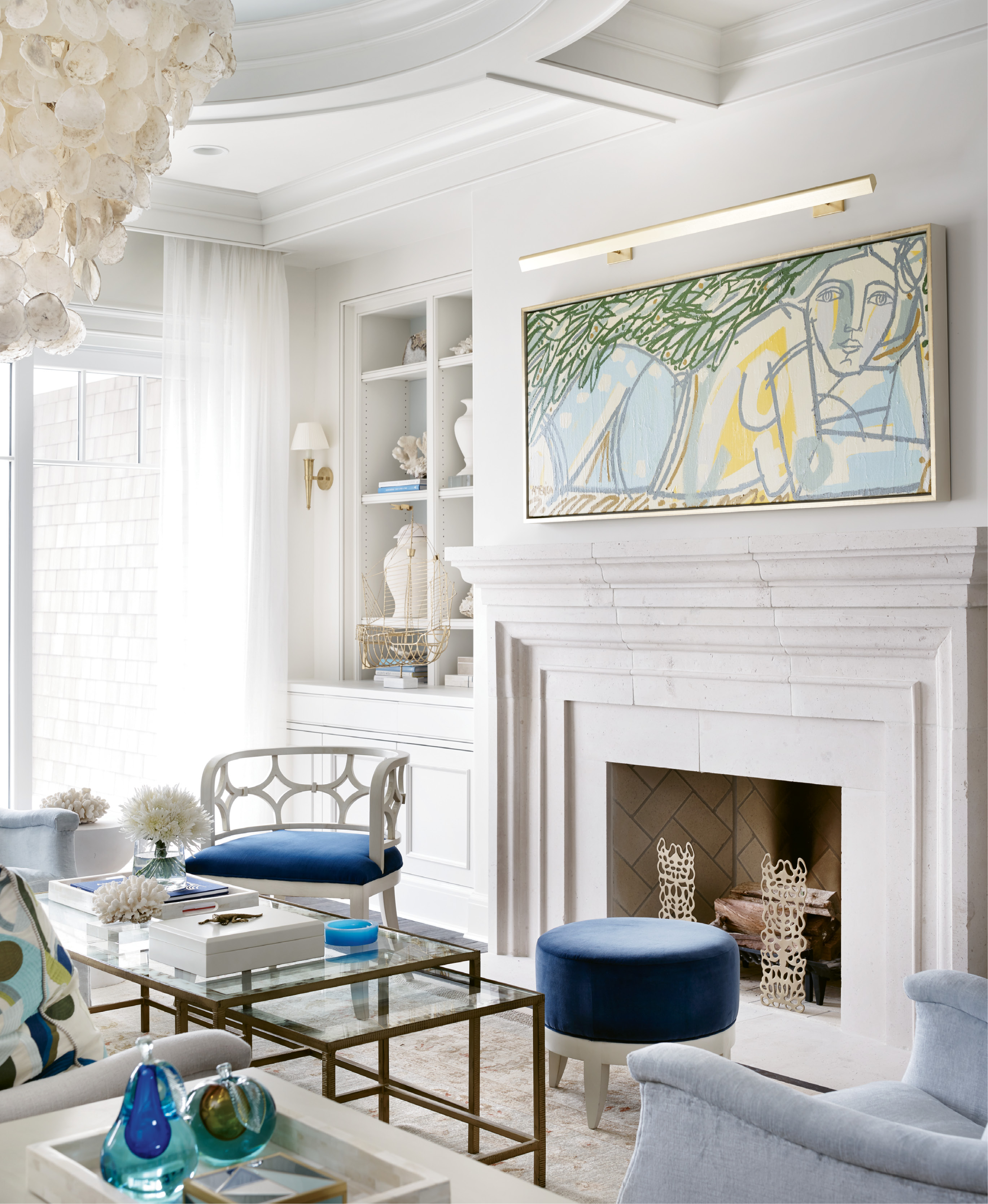 A painting by Colombian-American artist America Martin presides over the hearth.