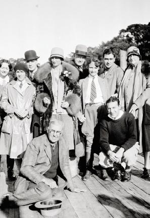 Belle (pictured in fur coat and hat) with family and friends on the Hobcaw dock in 1935;