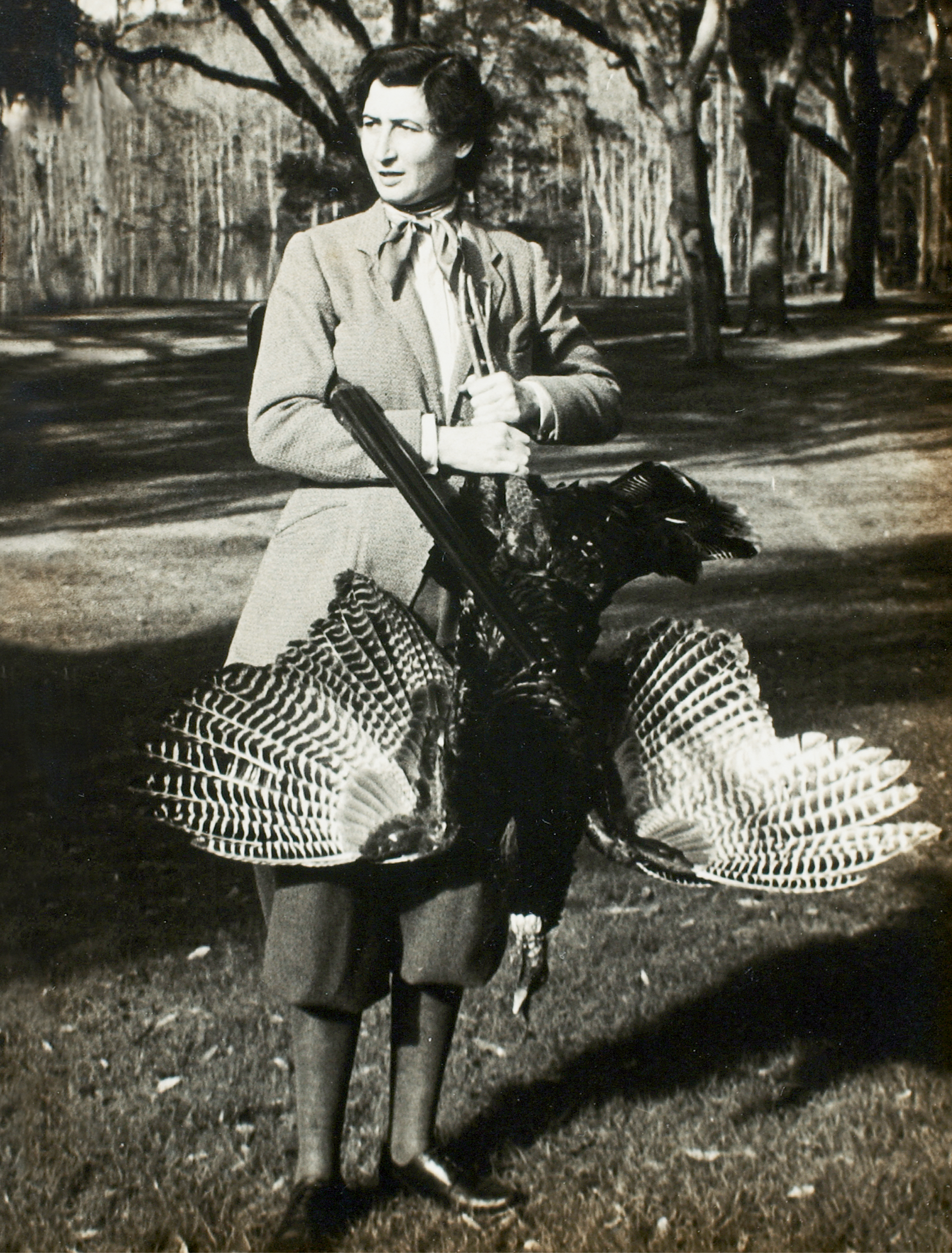 Belle Baruch during a 1936 turkey hunt at her family’s 16,000-acre winter retreat, Hobcaw Barony, near Georgetown, South Carolina; (opposite) the Baruchs, circa 1905, with staff and guests on the porch of “Old Relick,” the original main home on the property