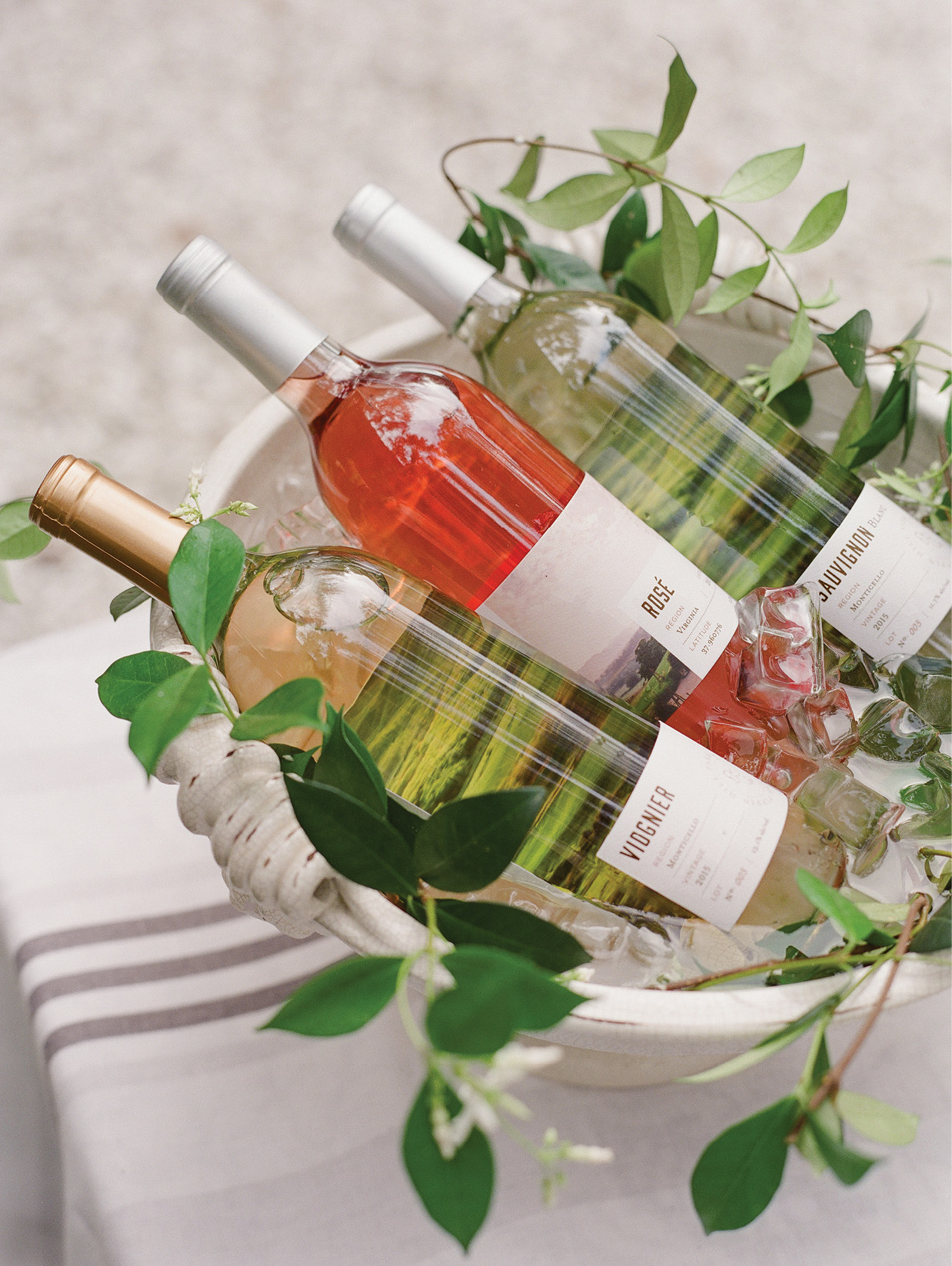 For the “bar,” Lynn filled a Vietri planter with ice and just-plucked jasmine vines to chill a variety of their Pippin Hill Farm &amp; Vineyard wines.