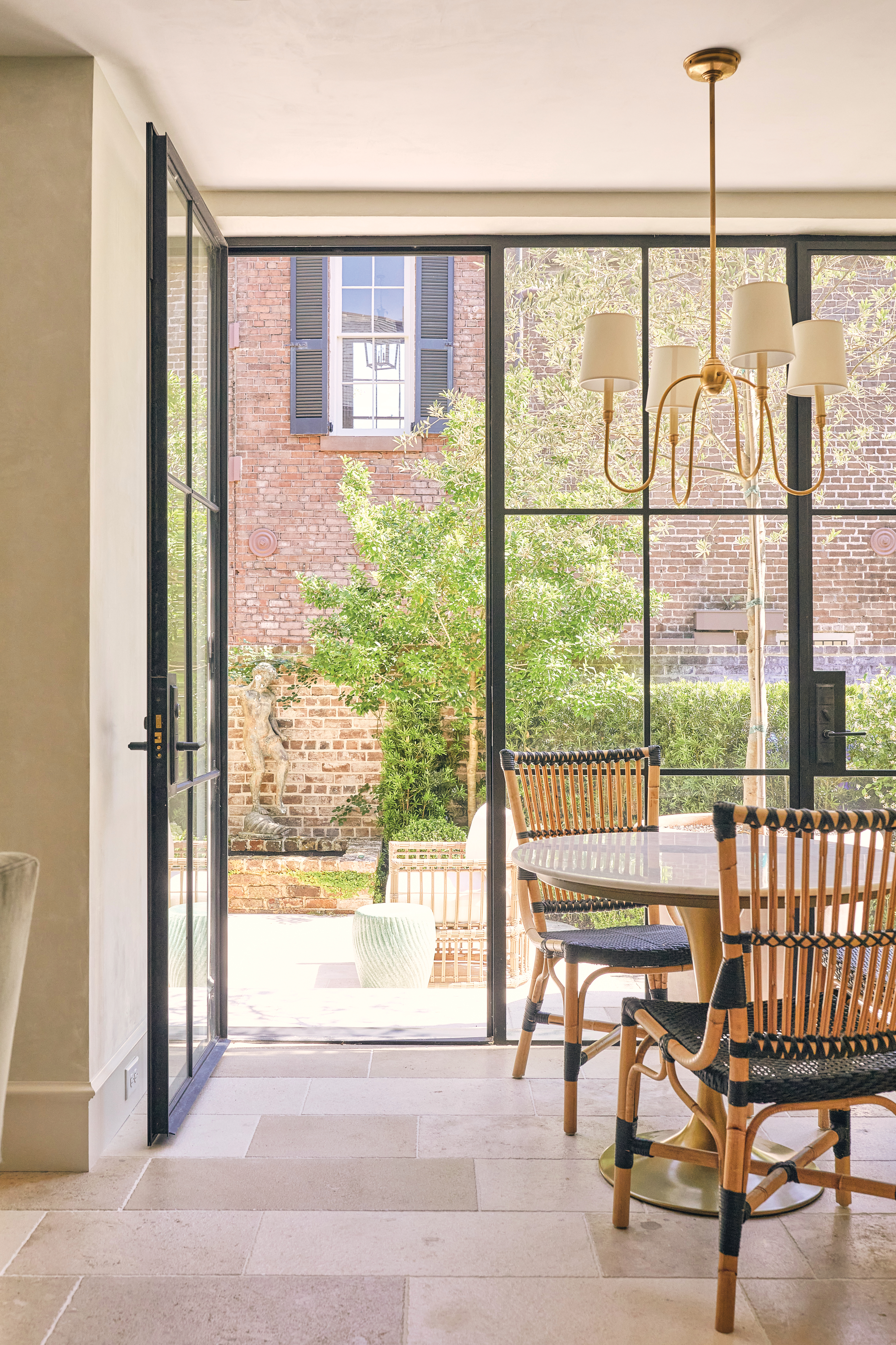 Large powder-coated, steel-framed windows allow in plenty of light while creating a cozy breakfast nook with a view of the courtyard.