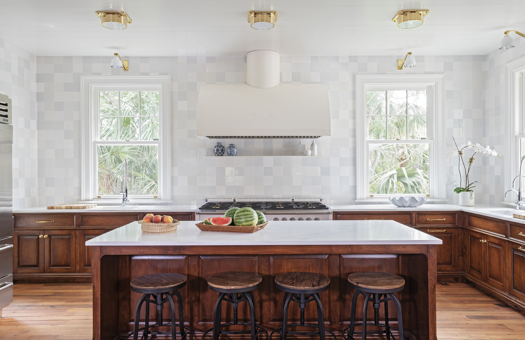Brass ceiling lights and wall sconces from Urban Electric in the kitchen continue the nautical motif, while the Delft tile in an off-white mix adds depth and dimension.