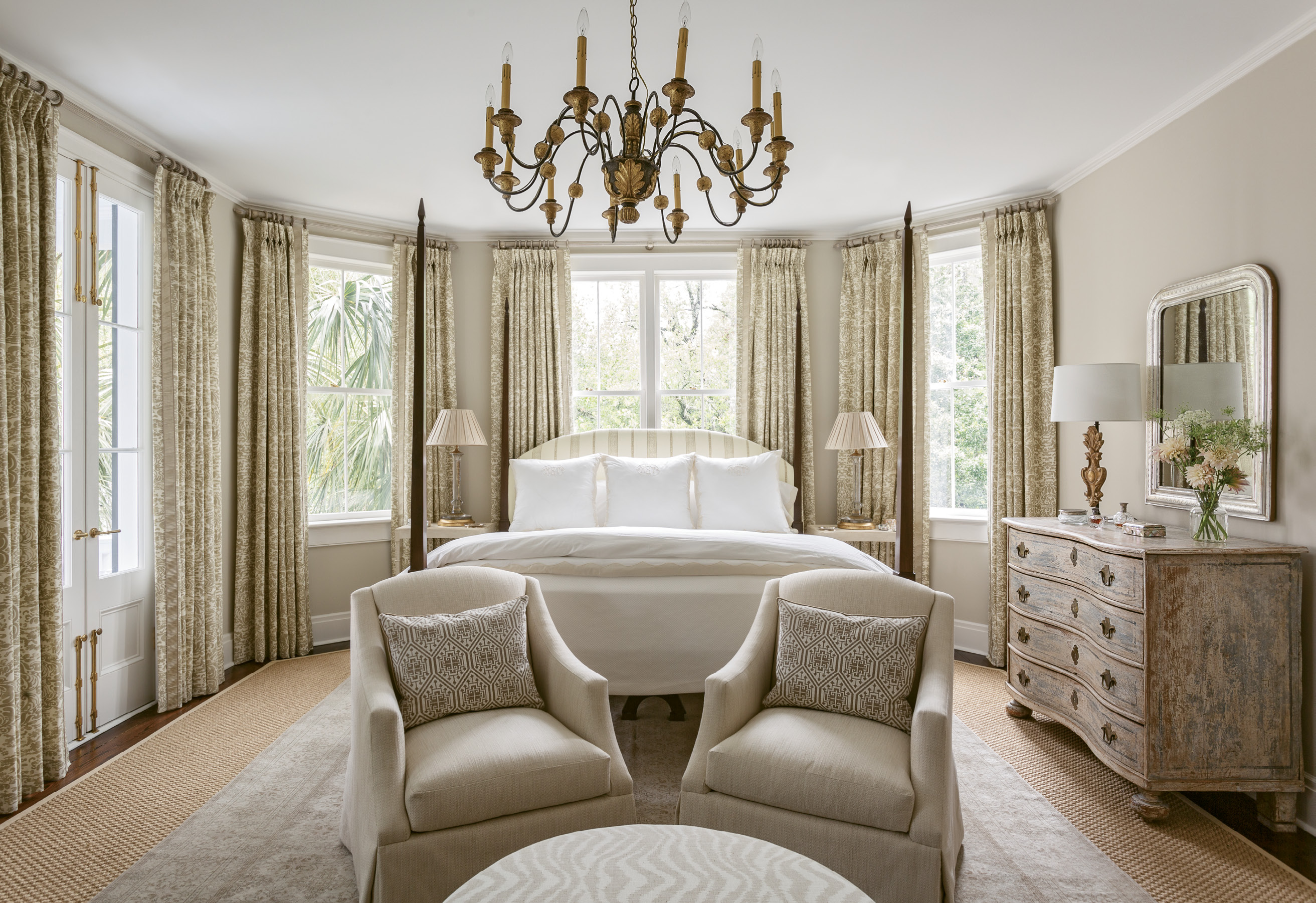 TONY TONES: Taupe, camel, and cream are enlivened with understated patterns and hints of the tropical foliage just beyond the windows in this soothing master bedroom, with a custom poster bed by North Charleston’s Nietert Antique Restorations.