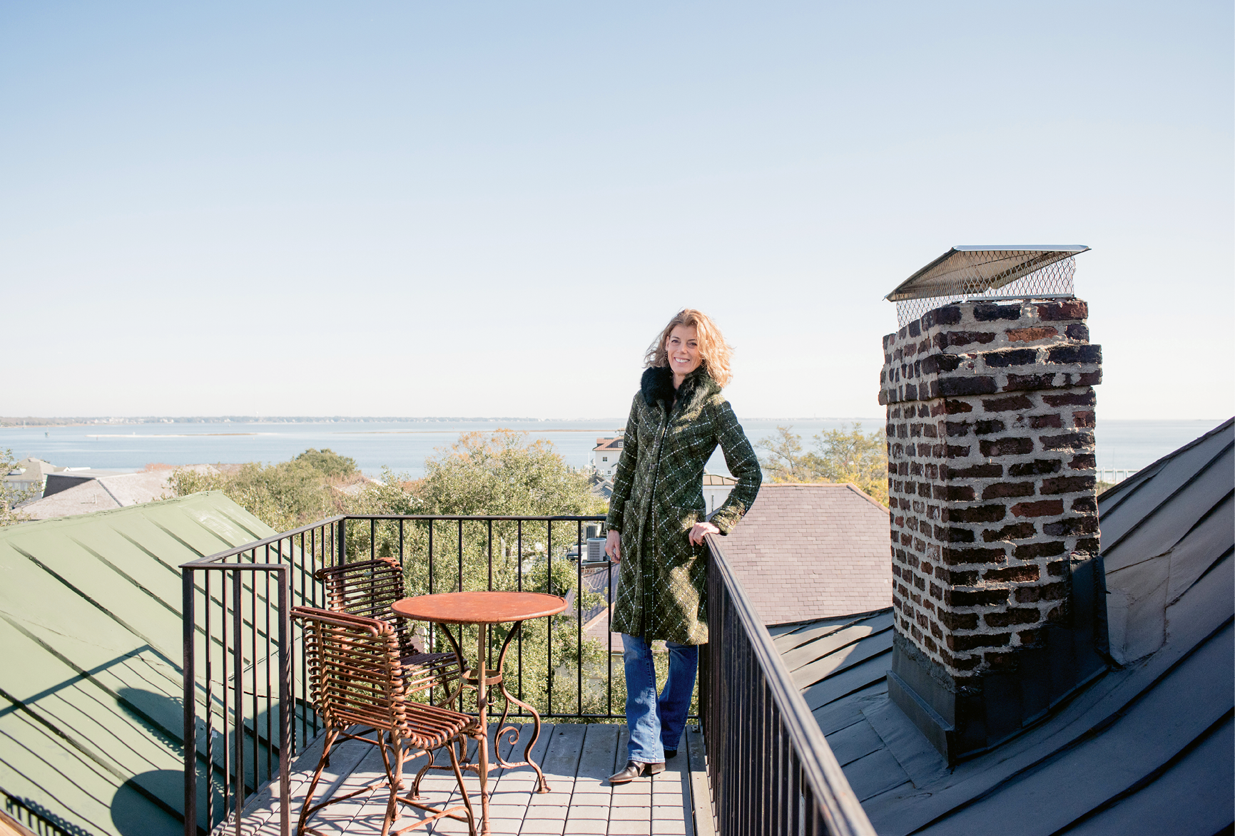 THE LONG VIEW: Pollak takes in some fresh air from her four-story home’s petite rooftop deck, which offers stunning views of Charleston Harbor and Fort Sumter.