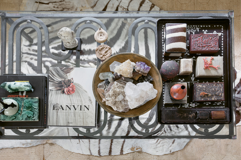 Collections of crystals and antique boxes are displayed on the coffee table