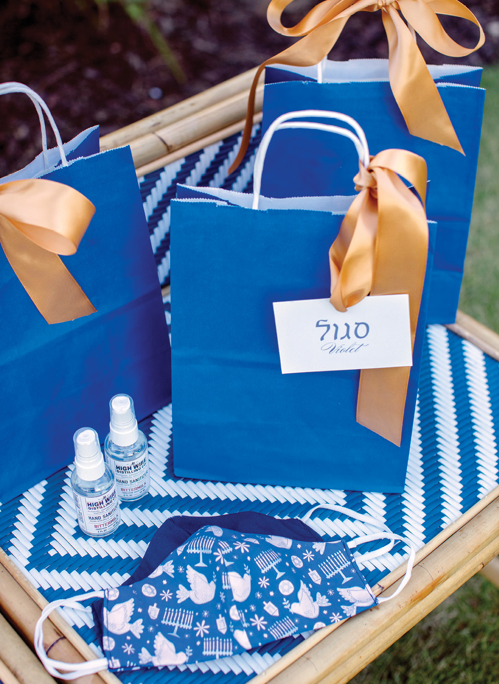 Hanukkah’s blue and white palette is accented by silver, as well as gold, in the welcome bags, which offer local Bittermilk hand sanitizer and festive masks