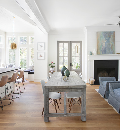 Sit A Spell: In a home designed for entertaining, seating is a main priority. “Slope” leather counter stools from West Elm line the island, while a bevy of mod molded-plastic chairs surround the rustic trestle table from Celadon. The central spot is in use most days, whether it’s dinner for two or game night with friends