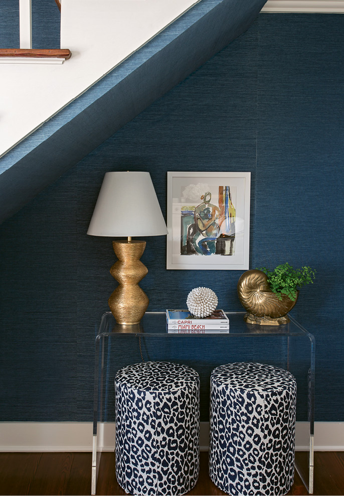 Similarly, a Lucite console disappears into a small nook under the stairs, allowing cherished pieces, such as the Anne Darby Parker painting, to shine.