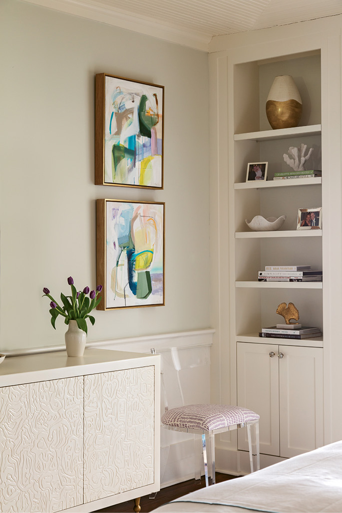 A hand-carved credenza by Kelly Wearstler is flanked with locally commissioned abstract paintings by Emily Brown.