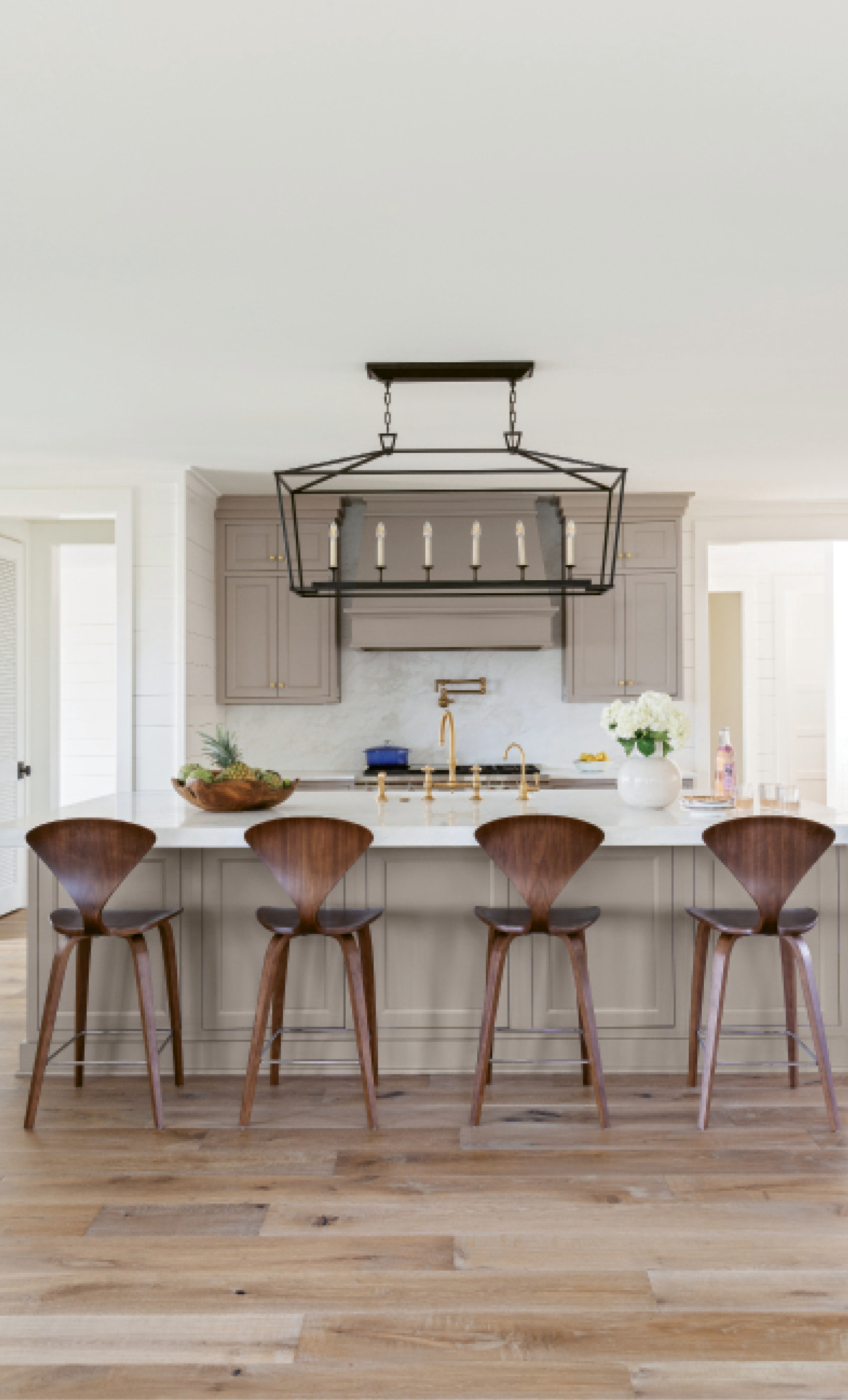 Style &amp; Simplicity: A minimalist kitchen is accented by mid-century modern stools from Design Within Reach, while the usual cooking accoutrements can be found in the butler’s pantry, right off the kitchen.
