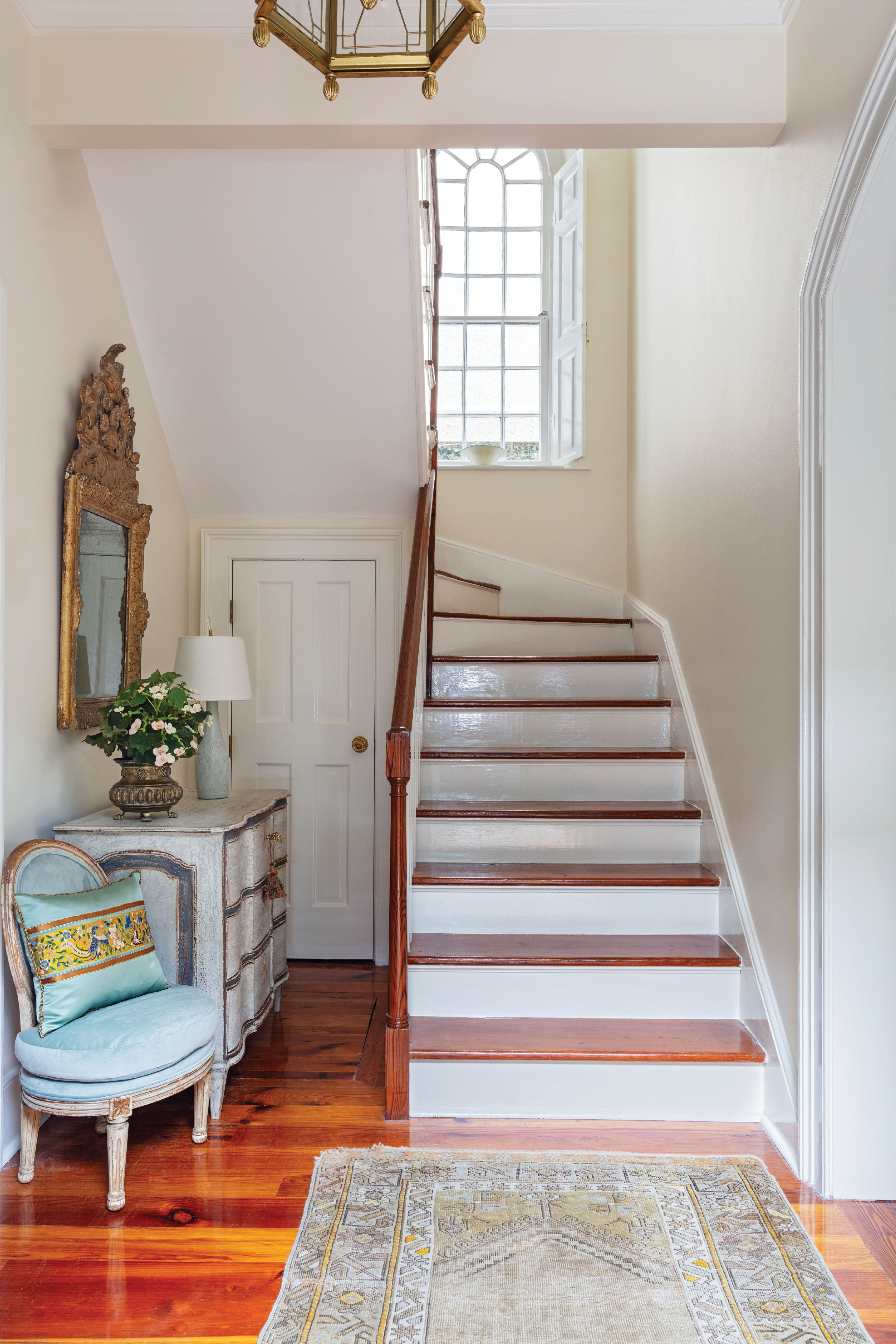 he home’s entryway, flanked by the drawing and dining rooms, features original heart-of-pine floors, an 18th-century French Régence gilt-wood mirror, and a Baroque chest of drawers.