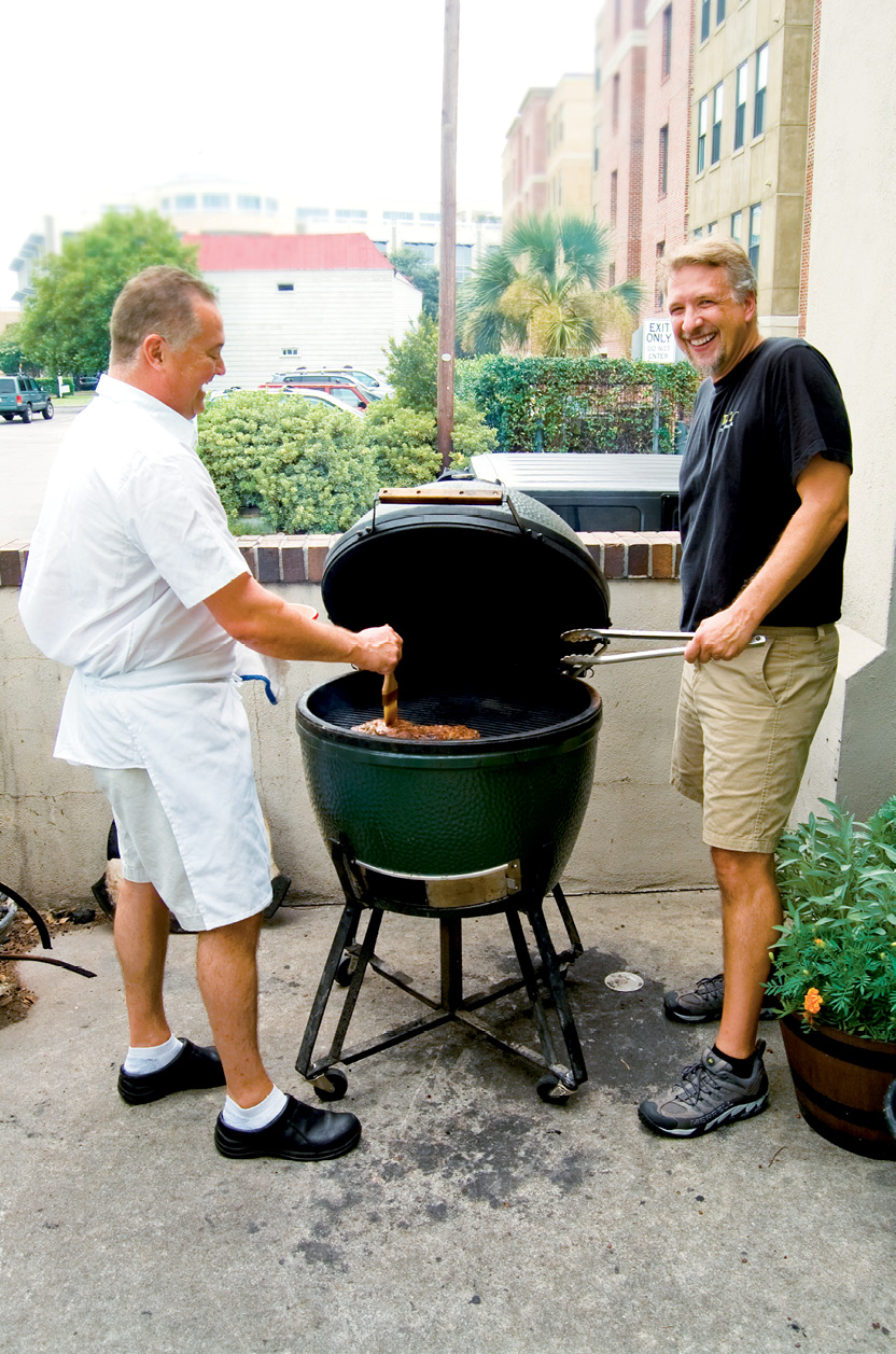 BUTCHER: Ted’s Butcherblock; here, Ted Dombrowski (right) cooks out with Peninsula Grill chef Graham Dailey on the Big Green Egg out back.