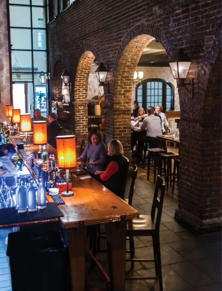 Casual Classic: Brick archways inside the historic building have shed their once-dramatic stained glass alcoves, bringing the former tavern closer to its relaxed roots.