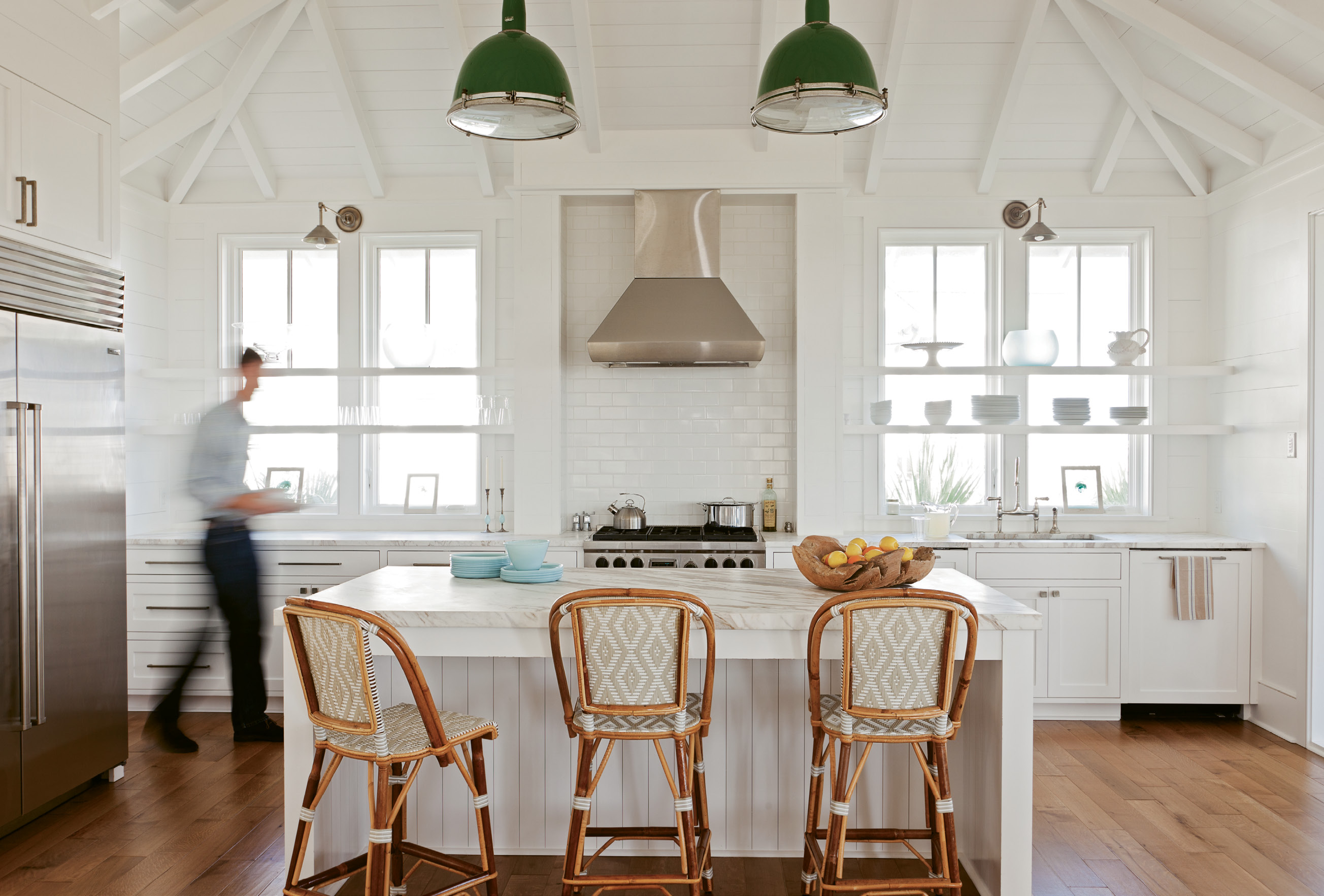 Bright Ideas: Keenan refashioned two old gymnasium lights, hung by a whipped rope cord, as kitchen pendants, adding a pop of color to the mostly white space.