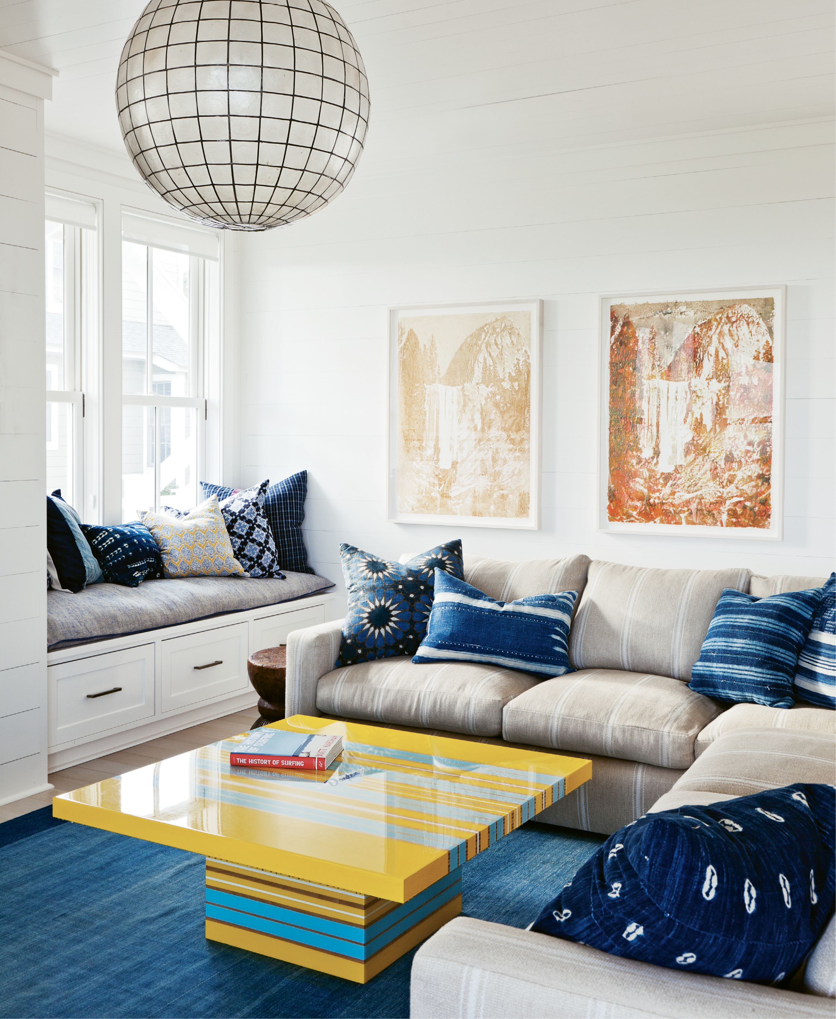Surf’s Up: The family room is a primo spot with a bright yellow and blue surfboard-inspired coffee table. Delicious artwork by Matthew Brandt is made of Gummi Bears and Pixy Stixs.