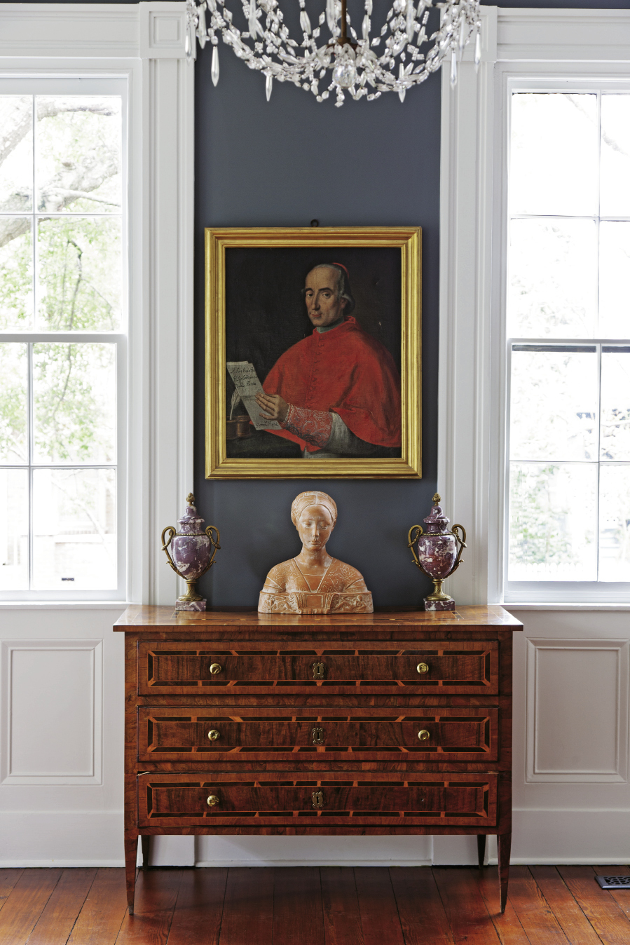 A 16th-century portrait of Cardinal Ardicinus della Porta hangs over a bust of an Italian princess in the front parlor