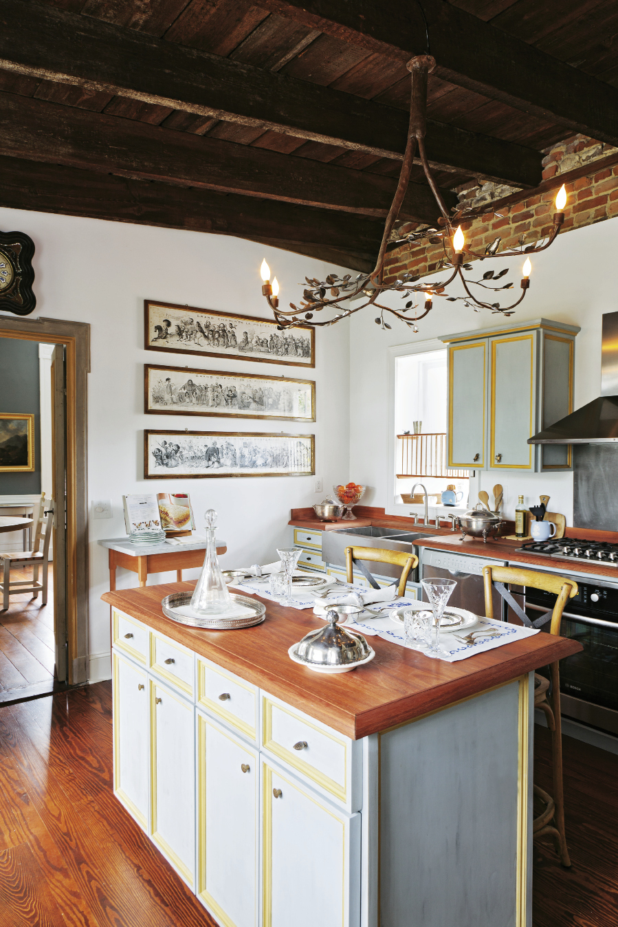The kitchen  island was built in the style of old Tuscan cupboards by local firm Perrin Woodworking; the chandelier is by Umbrian blacksmith  Alberto Alunni.