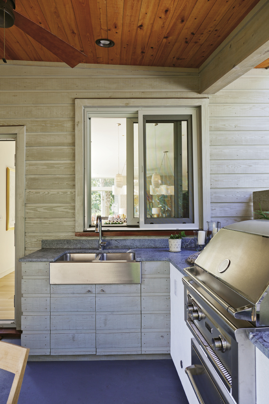 Soapstone countertops work in the covered outdoor kitchen because they weather the elements