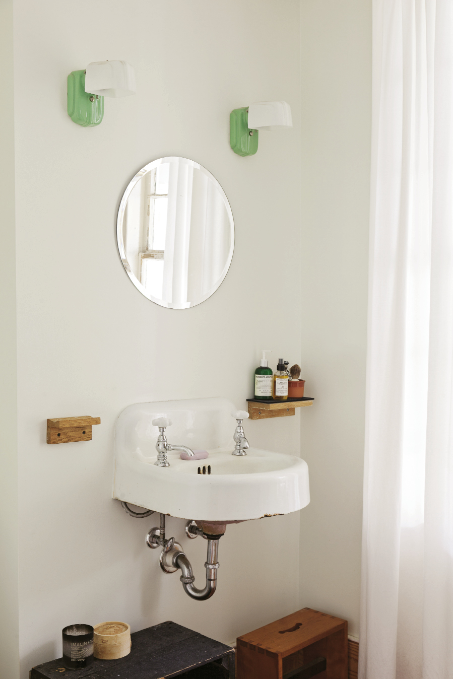 In the bath, retro-inspired sconces suit the original sink.