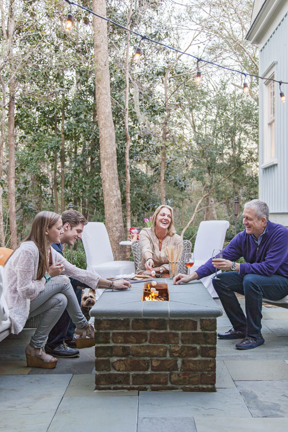 Hot Spot: Boasting a gas fireplace and stunning woodland views, the rear courtyard is the family’s favorite place to hang out.