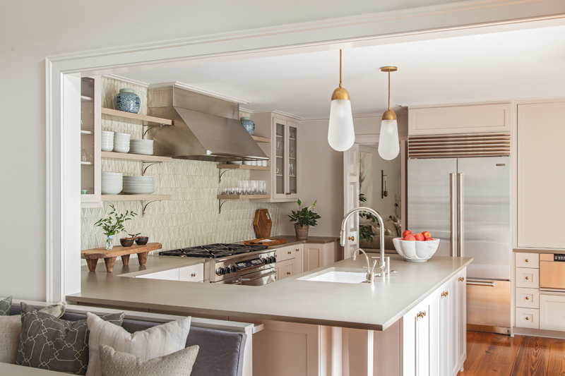 In the kitchen, existing countertops were refreshed with an iridescent tile backsplash and gilded pendant lights.