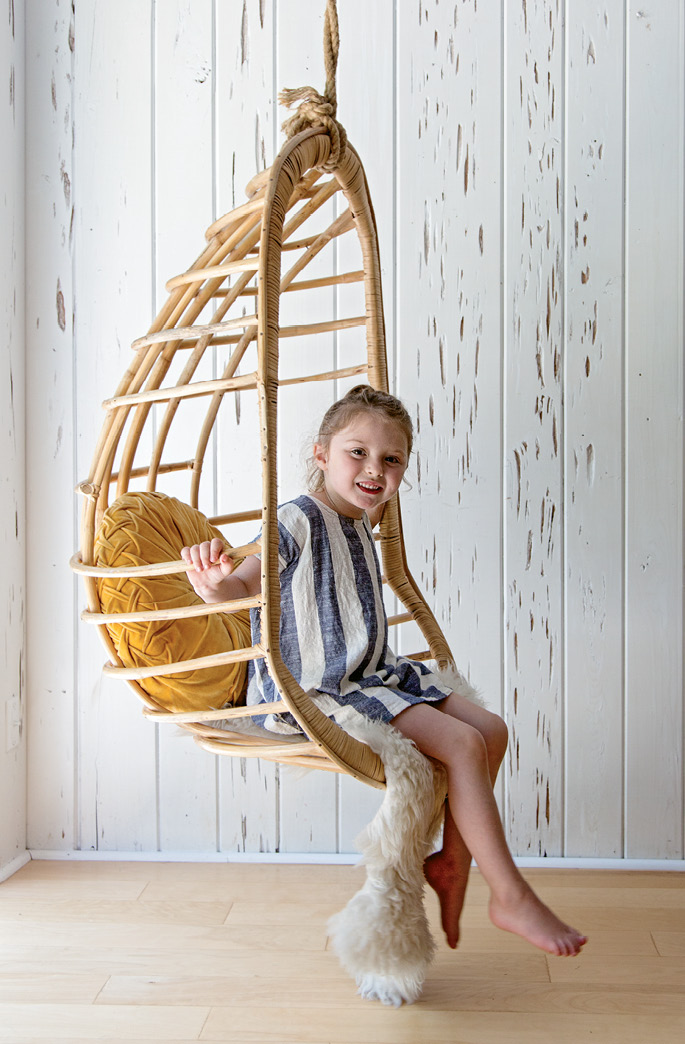 Sunny enjoys the cool hanging swing from Eclectic Charleston