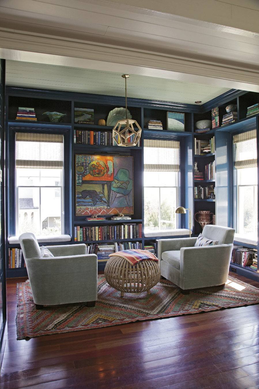 In this cozy reading nook off the kitchen, Bishop designed the built-in shelves, which were  constructed by area builder James Meadors. She also choose the paint color, a shade of blue that matches the deep waters of the sea.