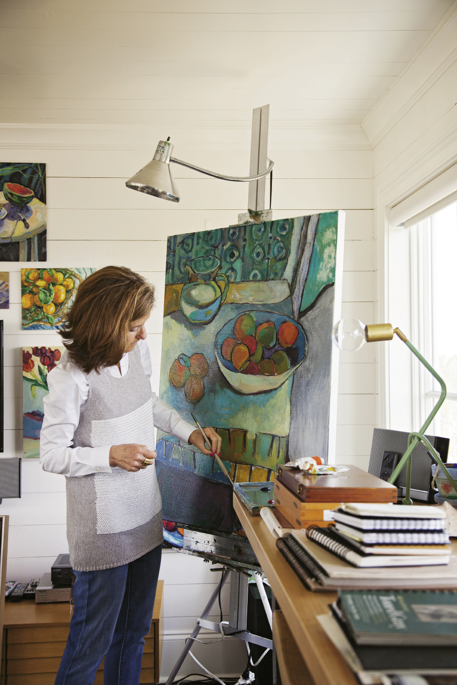 Each day, the artist spends time painting in her sunlit third-floor studio.