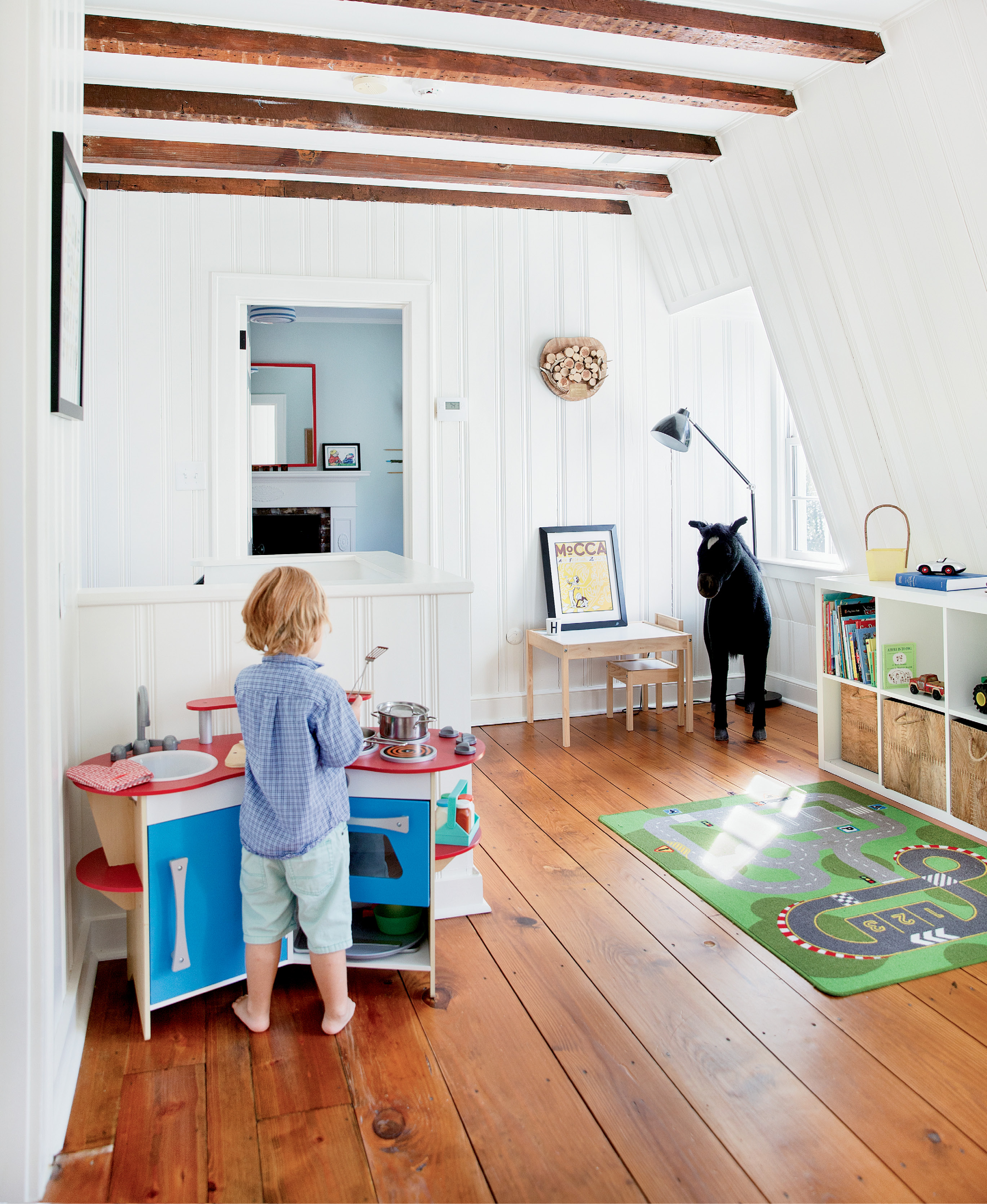 Henry whips up some pretend grub in his playroom, which retains its 18th-century footprint, as does his adjoining bedroom.