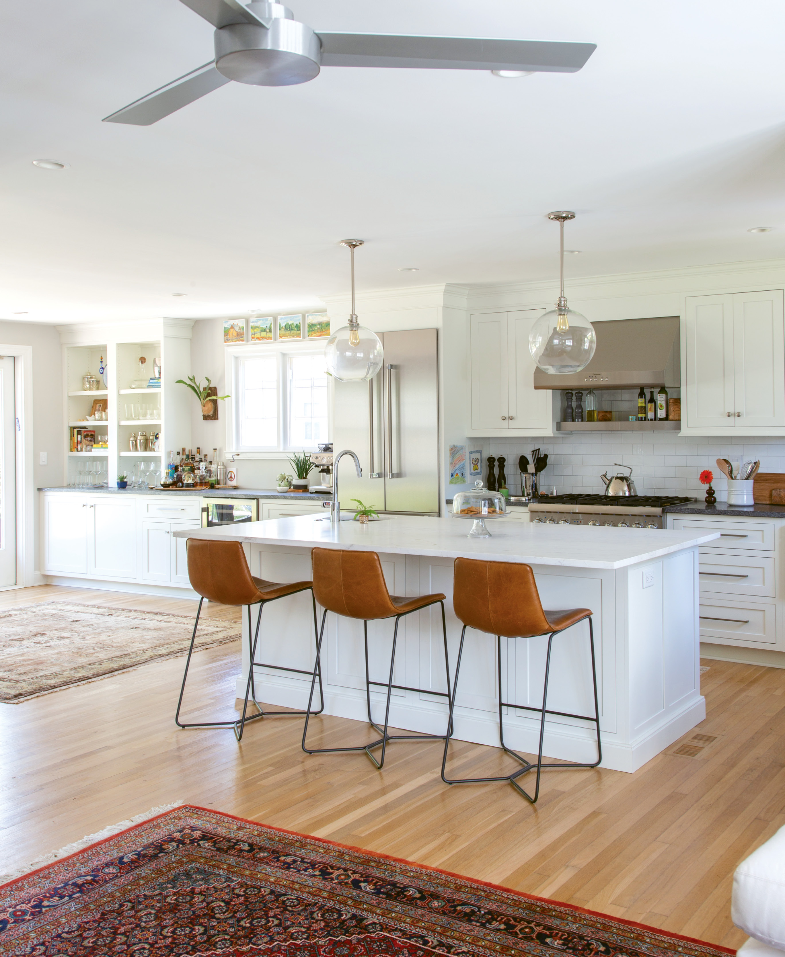 CLEAN SLATE: This Wagener Terrace home’s modern kitchen may be picture-perfect today (with its West Elm barstools, sprawling marble island, and pristine subway tile), but less than two years ago it was dark, dingy, and seriously outdated.