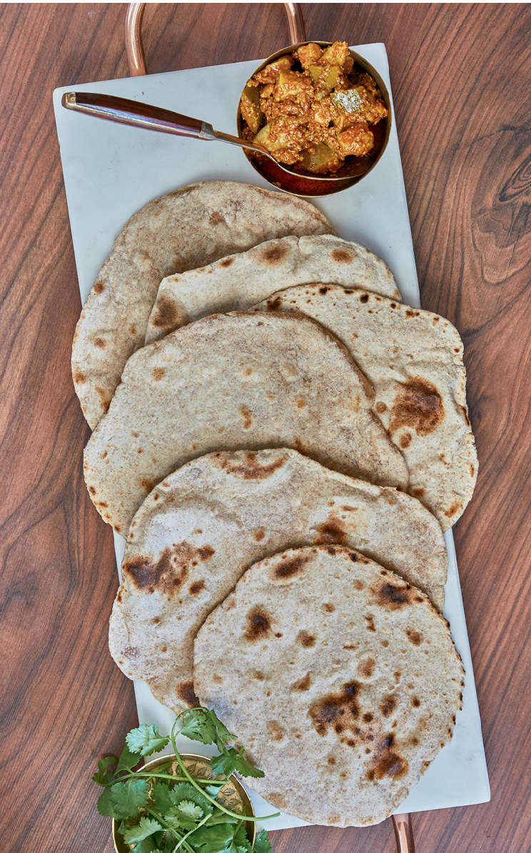 Chapati, a traditional Indian flat bread, is used to scoop up curry dishes at the dinner table.