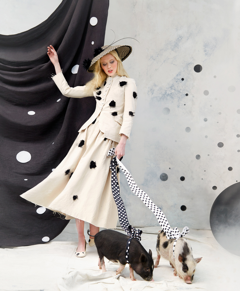 Polka Dot Promenade: Checkered saucer hat, $475 at Carolina Millinery Company; Elena Dawson “Rosebud” canvas hacking jacket and skirt with black rosebuds, $2,495 and $2,195 at Worthwhile; Chloe “Lauren” scalloped leather heel, $575 at RTW; pigs, Gabby and Elf, courtesy of All Thing Acre Petting Zoo