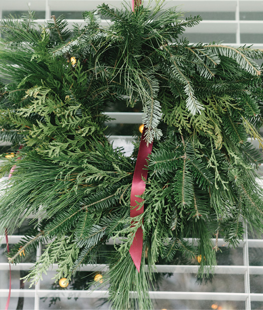 She also created three simple pine wreaths for the front windows.