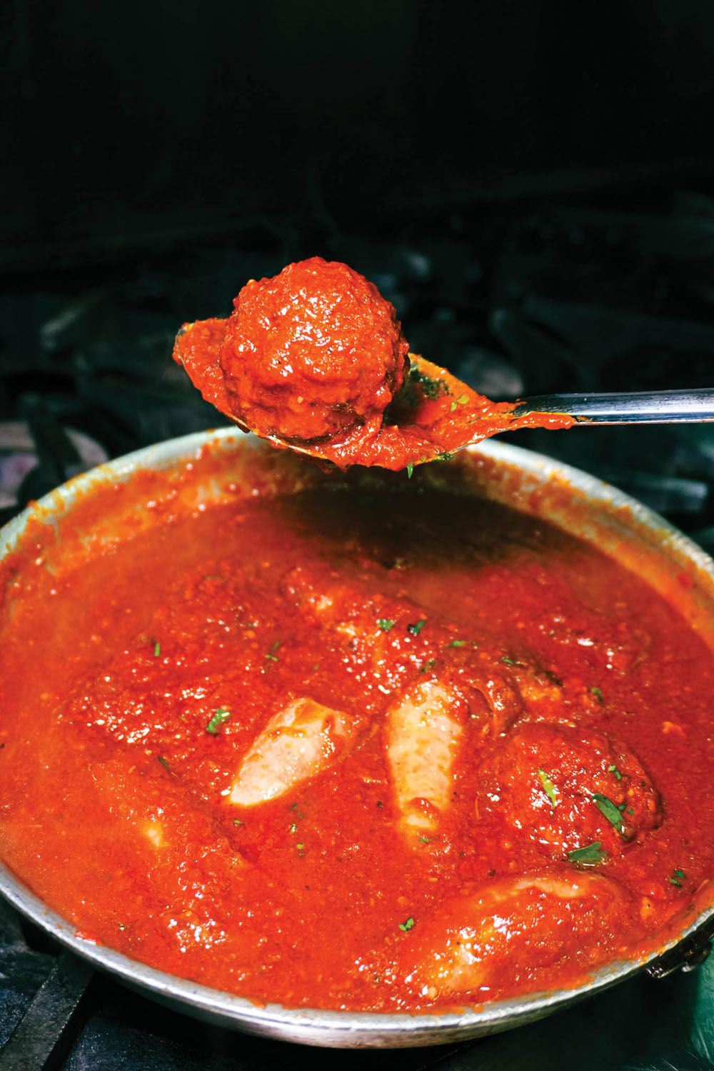 a meatball in Sunday Sauce