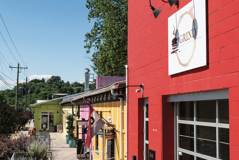 The colorfully painted former textile warehouses known as Pink Dog Creative are home to 34 artists, two restaurants, and Grind AVL Coffee Bar.