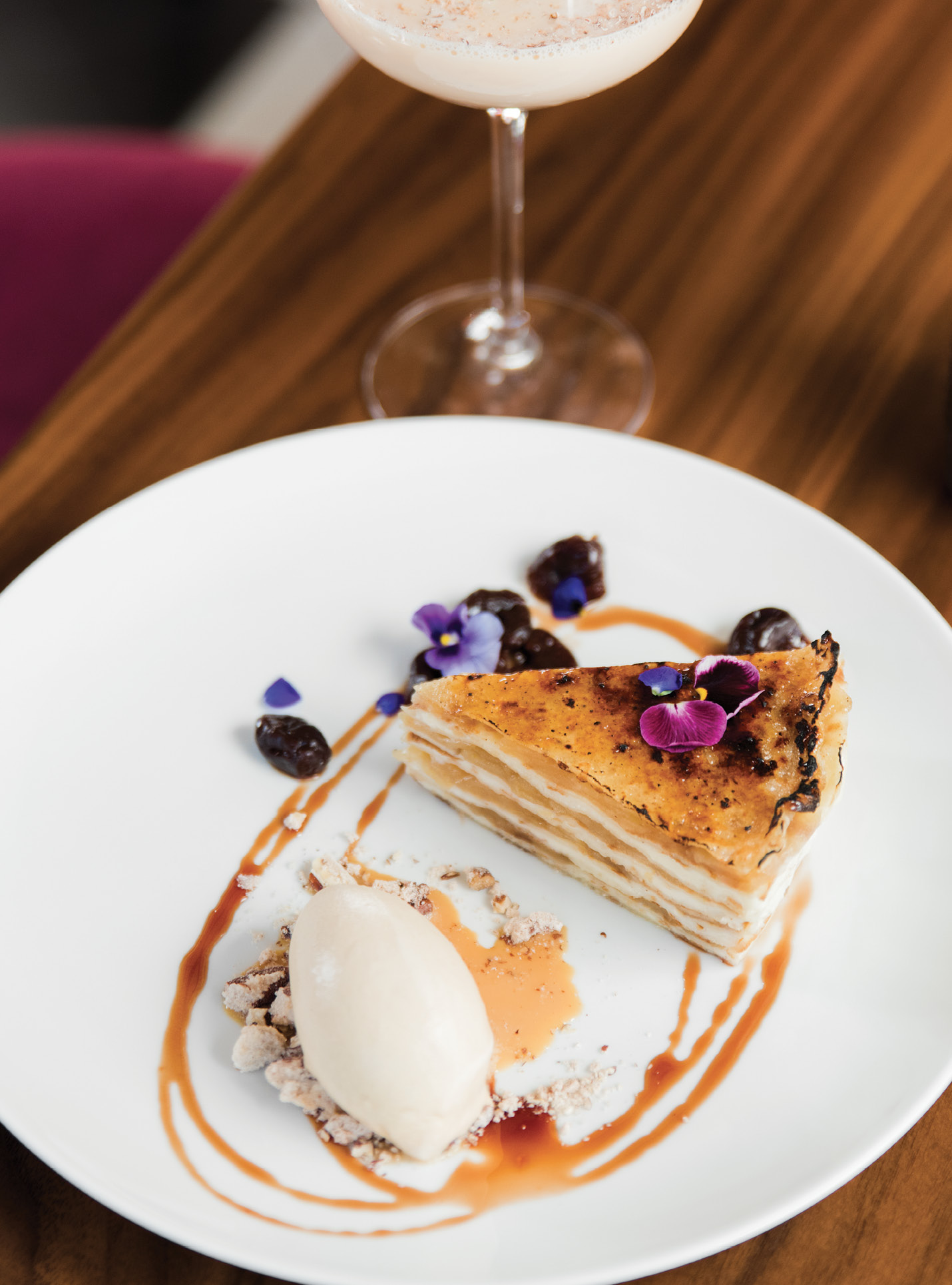 Layered beauty: Pastry chef Jenn McCoy’s flower-adorned apple crêpe cake pairs well with bar manager Ryan Casey’s White Elephant cocktail.