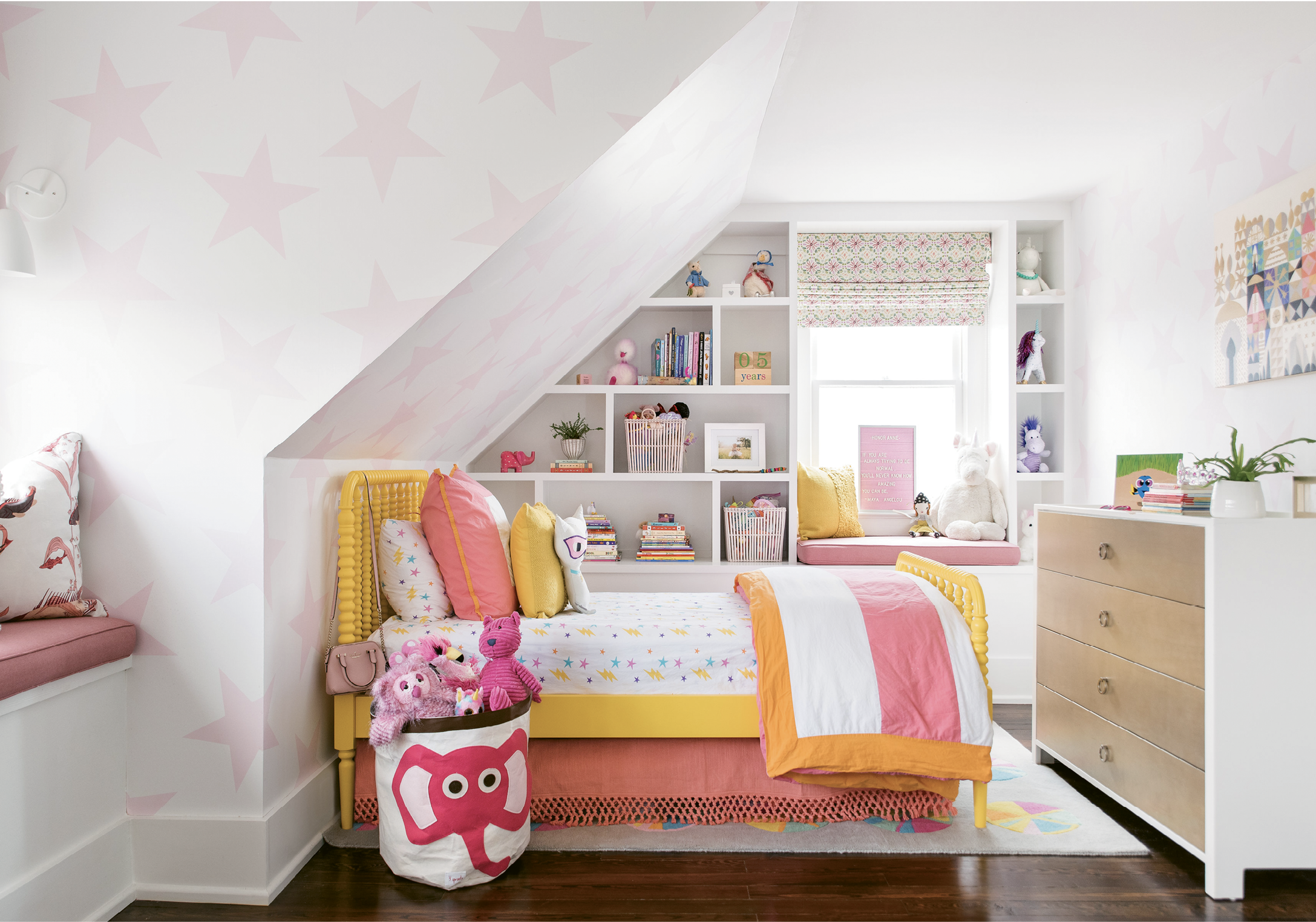 HAPPY DAYS - The third floor houses Honor and Finn’s rooms and their cheerful bath. “I feel like we did a good job at giving these a magical feeling, a place for them to be little kids,” says Parker. Playful wallpaper—Sissy+Marley’s “Lucky Star” for her