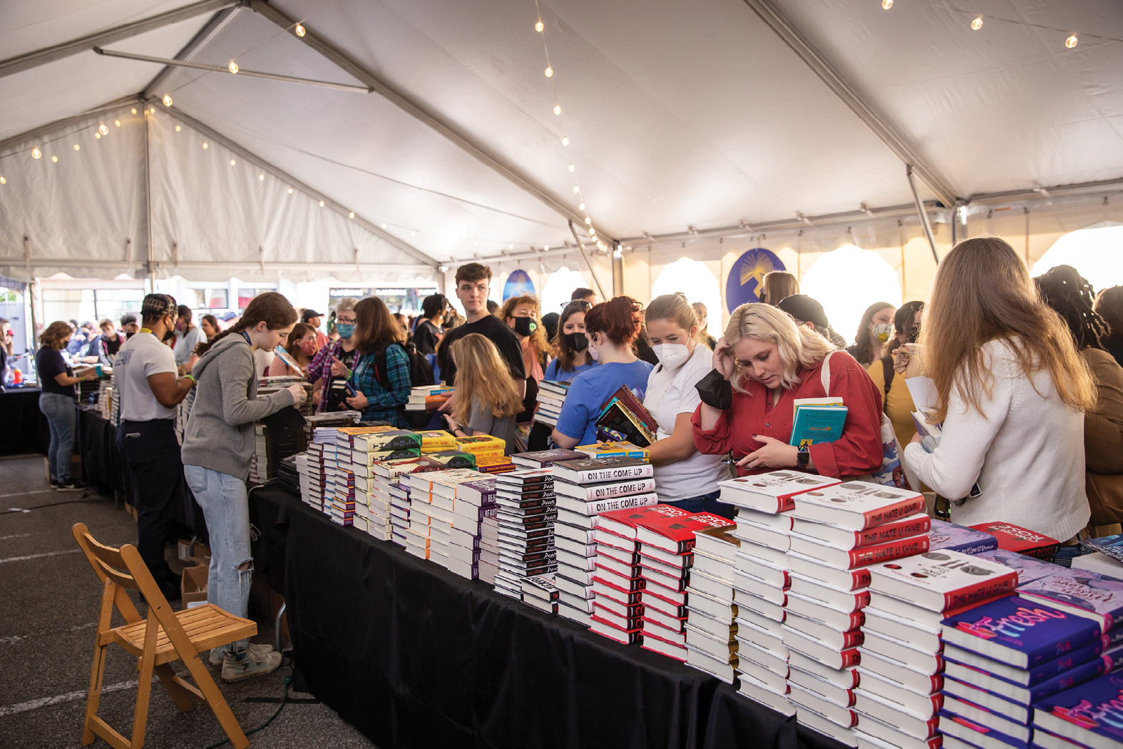 Readers stock up on the newest titles from their favorite YA authors at the YALLFest book tent in the parking lot adjacent to Blue Bicycle Books.