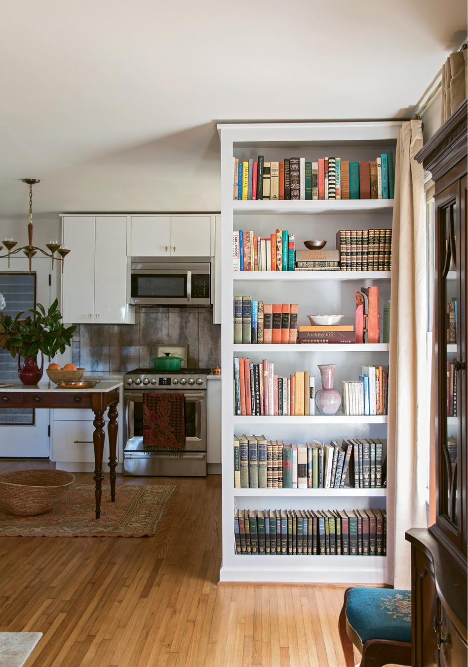 SHELF LIFE: To modernize the layout, Glennon advised taking down the wall separating the kitchen and dining nook. In its place, she added built-in bookshelves that keep the space visually open while still clearly defining individual rooms.