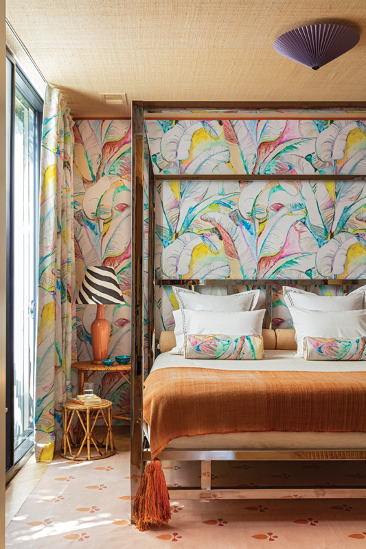The primary bedroom is swathed in a vibrant, banana-leaf print. A collaboration between Voutsa and CW Stockwell, the pattern is a reinterpretation of Stockwell’s iconic “Martinique” print originally designed for the Beverly Hills Hotel. “For me, it’s a collision of Miami and Los Angeles, two cities I love,” says Hranowsky. She commissioned artist Doug Meyer to create the cameo of Frida Kahlo.
