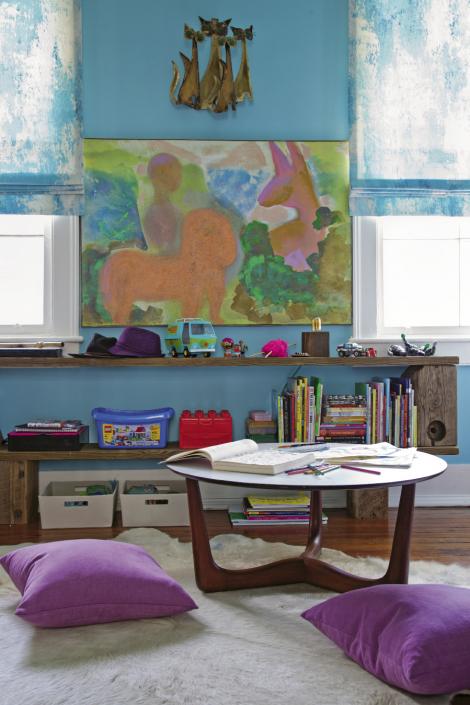 In Loulou and Sasha’s room, a Danish Rosewood coffee table with laminate top, a cowhide rug, and low shelving create a comfy kids’ work area.