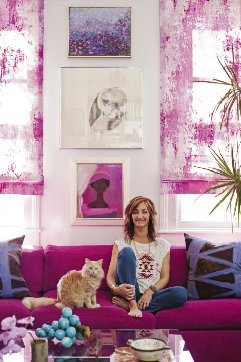 Angie (pictured with Rose the cat) re-covered this Milo Baughman sectional in a fuschia woven fabric by Glant.
