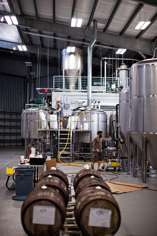 Assistant Brewers Scott Koon and Mike Levin brewing a batch (apple brandy barrels filled with Tripel in the foreground)