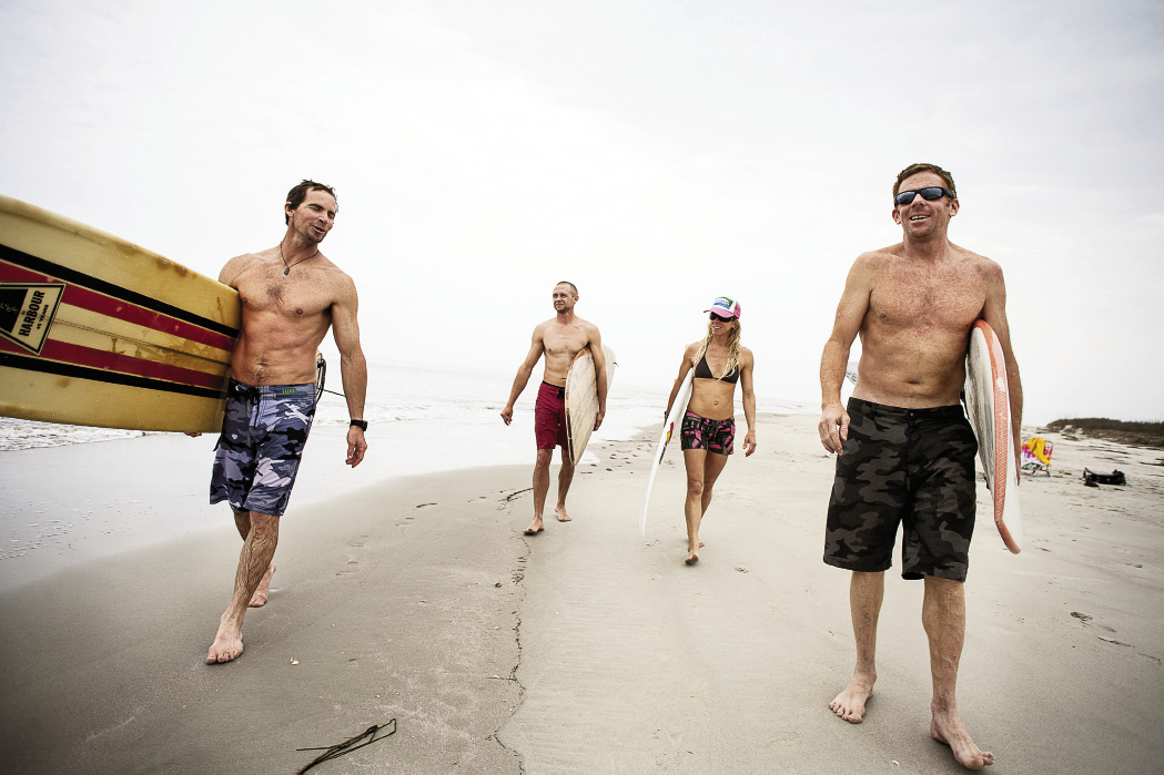 Chris Brown, Luke Pope-Corbett, Jenny Brown, and Chris Dixon walk along beautiful Sandy Point.