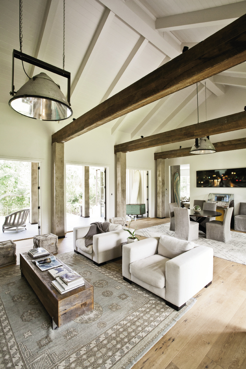 Three oversize sets of French doors join the lofty central room to the outdoors.