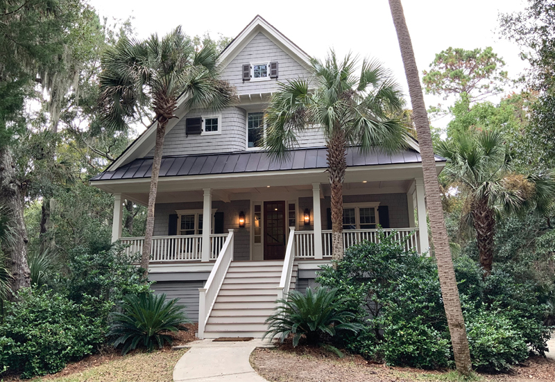 Live, Work, PLay: Kristin Peake and David Smith bought this Kiawah Island cottage in 2019 as both a retreat from their busy lives in Maryland and a Southern office for her interior design business. The project involved a complete renovation inside and out, including a new roof and front door; the addition of shutters and columns; and a gray, white, and charcoal exterior paint palette.