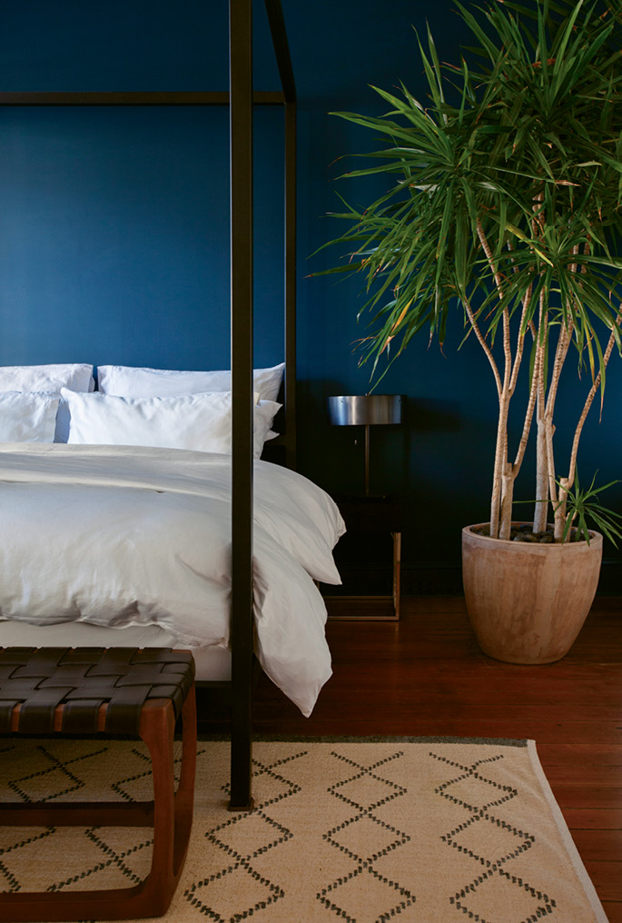 Cool Quarters: The deep marine-blue accent wall in the master bedroom