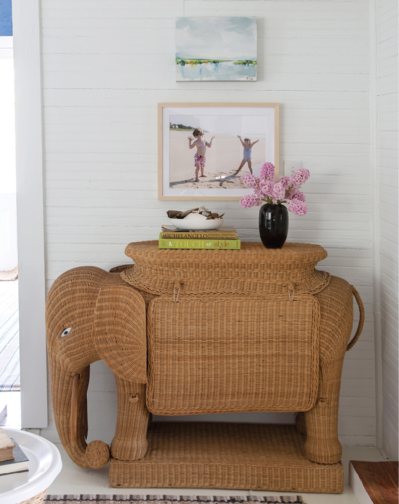 Unique finds, such as the vintage wicker elephant bar, dot the home. “I shop as much vintage as possible, because it adds so much character and individuality to a house,” says the designer.