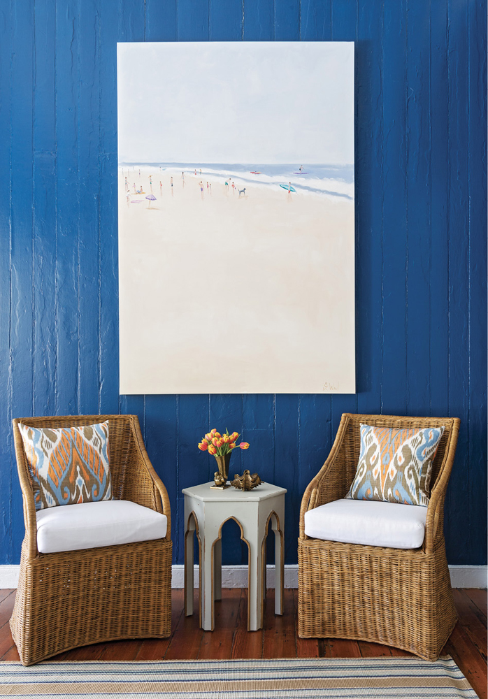Local artist Shannon Wood’s expansive beach scene pops from the bold blue walls. Beneath it, Williams-Sonoma Home wicker chairs invite visitors to sit and stay awhile.